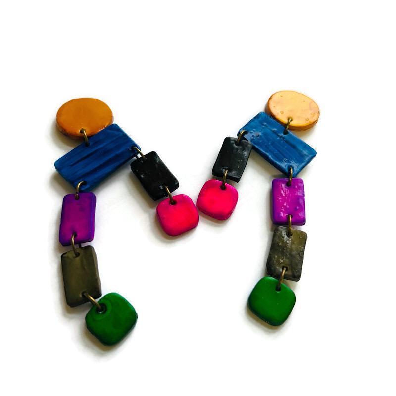 Colorful earrings with various shapes and sizes on a white background