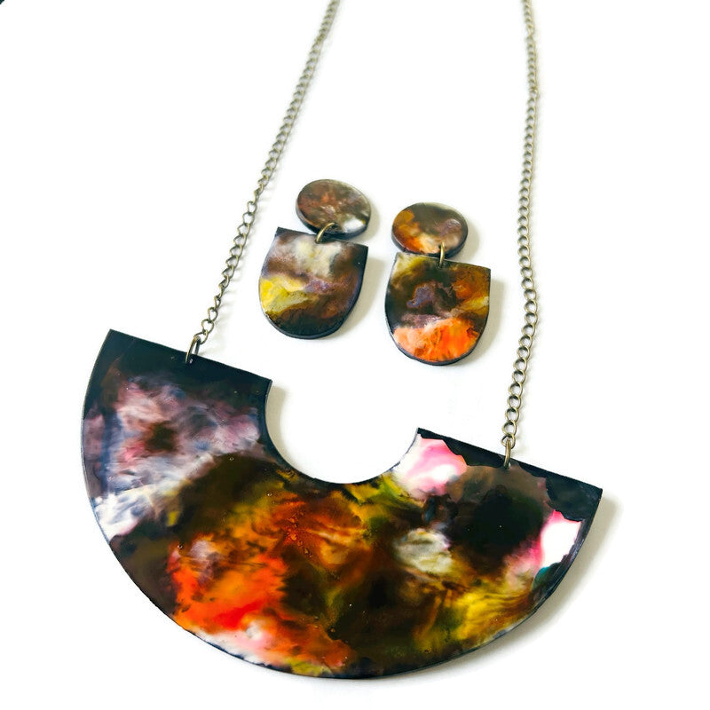 Jewelry set with a colorful necklace and earrings on a white background