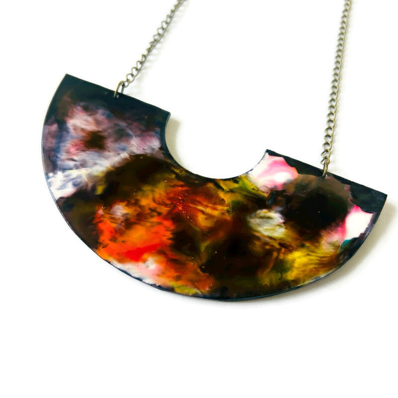 Colorful half-circle pendant necklace on a white background