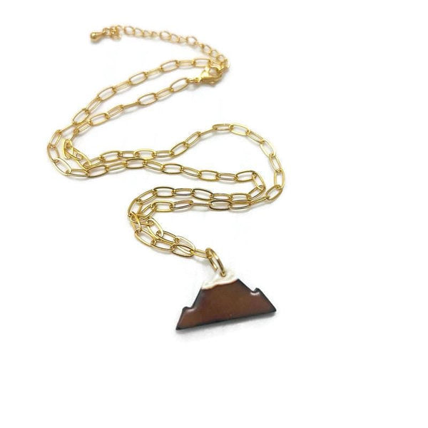 Gold chain necklace with a triangular pendant on a white background