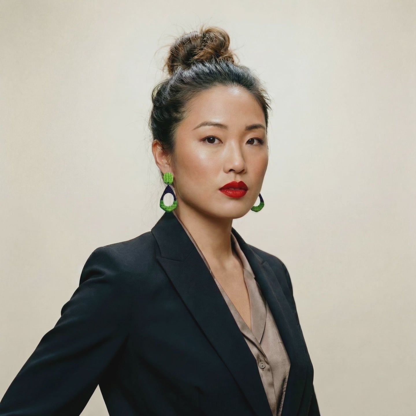 woman wearing blue and green earrings