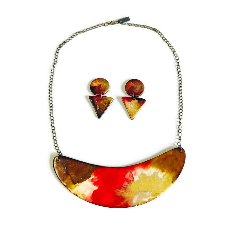 Colorful necklace and earrings set on a white background