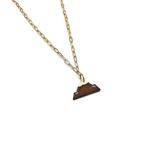 Gold necklace with a brown triangle pendant on a white background