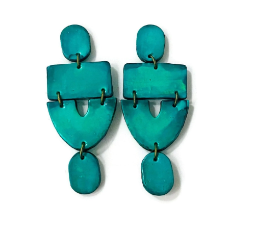 Turquoise earrings with geometric design on a white background