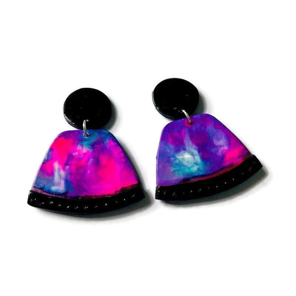 Colorful galaxy-themed earrings on a white background